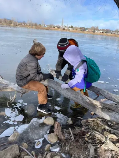 Children playing together by a lake